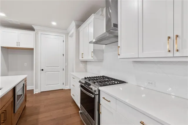 a kitchen with white cabinets and appliances