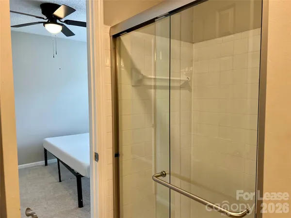 a bathroom with a shower and a sink