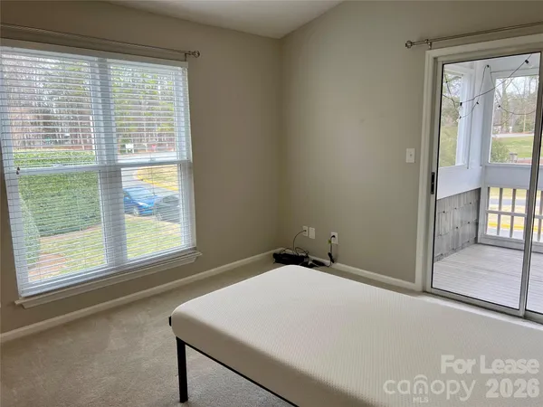 a room with a window and a ceiling fan