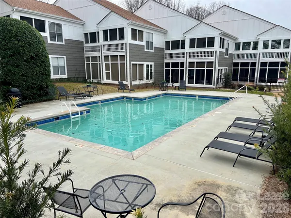 a view of a house with swimming pool and sitting area