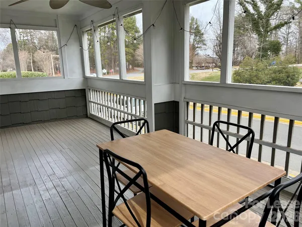 a view of a dining room with furniture a chandelier and wooden floor