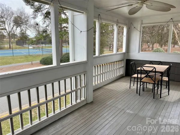 a view of a porch with furniture and a yard