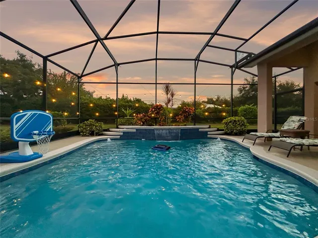 a swimming pool with yard and outdoor seating