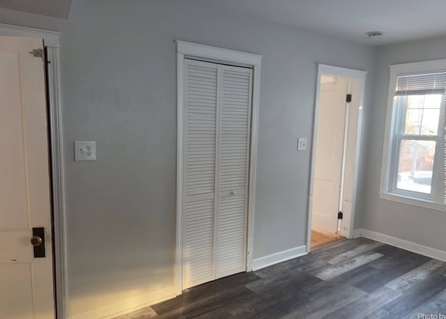 13 Merchant Street Worcester, MA 01603 - Photo 13 of 17 an empty room with wooden floor closet and windows
