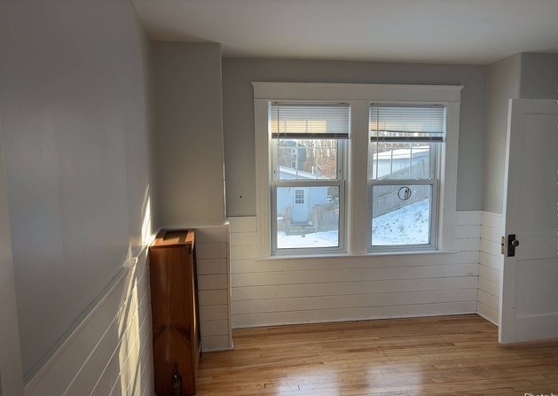13 Merchant Street Worcester, MA 01603 - Photo 14 of 17 a view of an empty room with wooden floor and a window