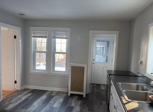 13 Merchant Street Worcester, MA 01603 - Photo 5 of 17 an empty room with wooden floor and windows