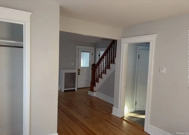 a view of entryway with wooden floor and stairs