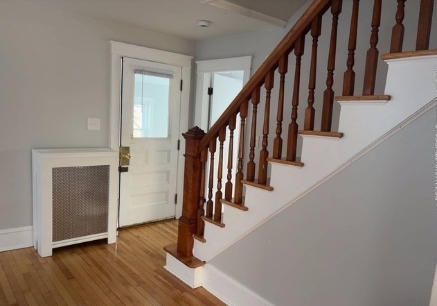 13 Merchant Street Worcester, MA 01603 - Photo 9 of 17 a view of hallway with wooden floor and stairs