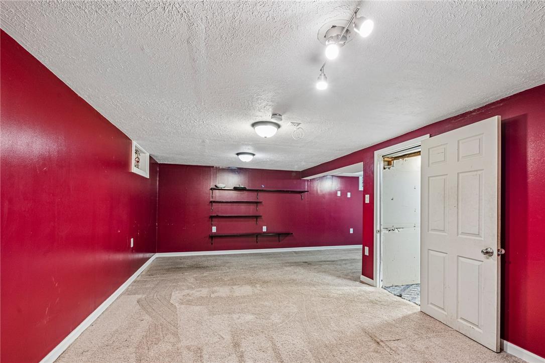 2428 Nottingham Road Bethlehem, PA 18017 - Photo 38 of 48 A spacious lower-level recreation area features bold red walls and cozy carpeted flooring.