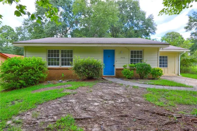 a front view of house with yard and green space