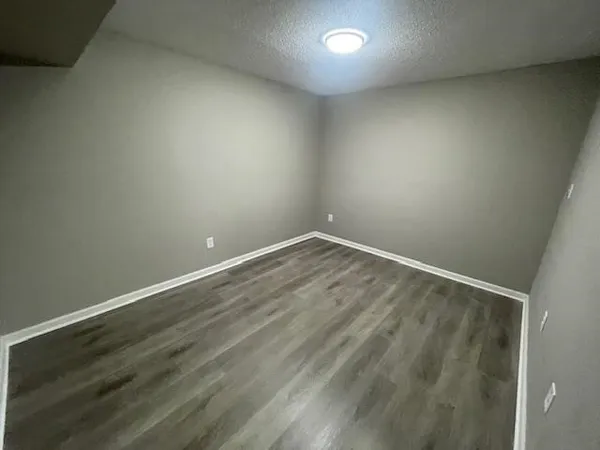 a view of room with wooden floor