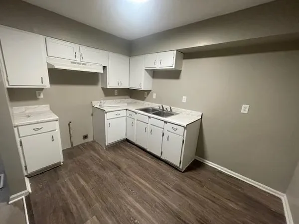 a kitchen with a stove oven and white cabinets