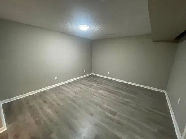an empty room with wooden floor