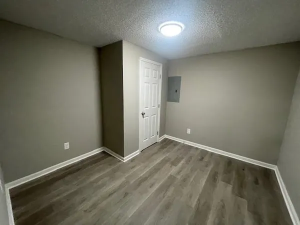 an empty room with wooden floor and closet