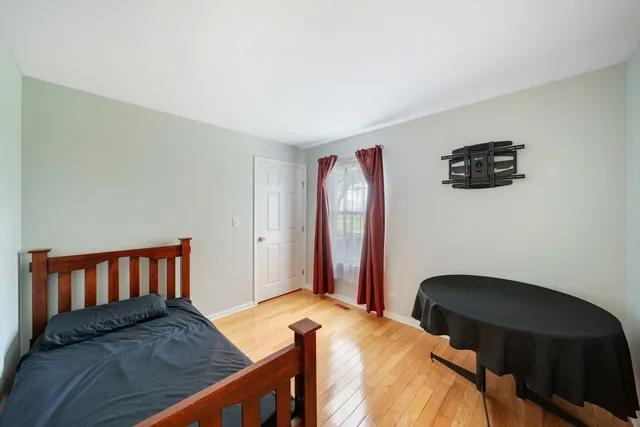 a bedroom with a bed and a chair in it