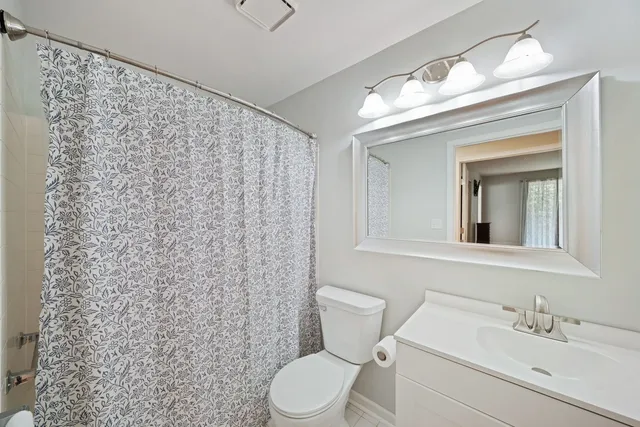 a bathroom with a toilet a sink and a mirror