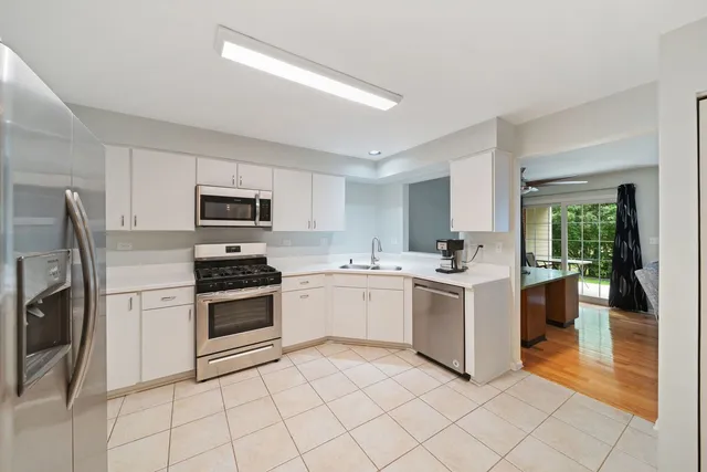a kitchen with a stove top oven sink and cabinets