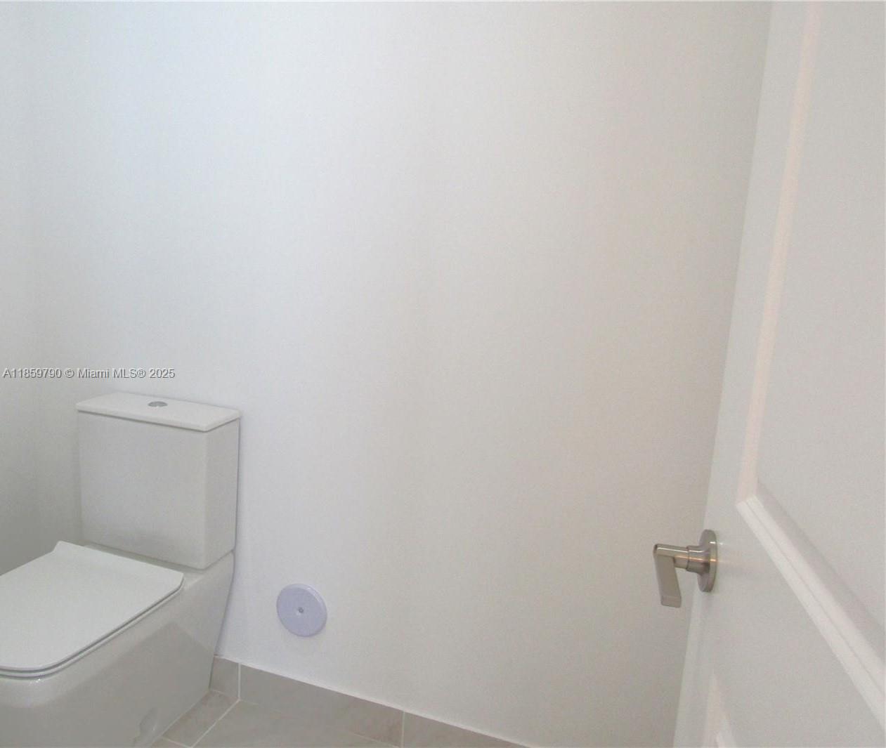 11998 Southwest 232nd Street Homestead, FL 33170 - Photo 11 of 30 a white toilet sitting next to a shower