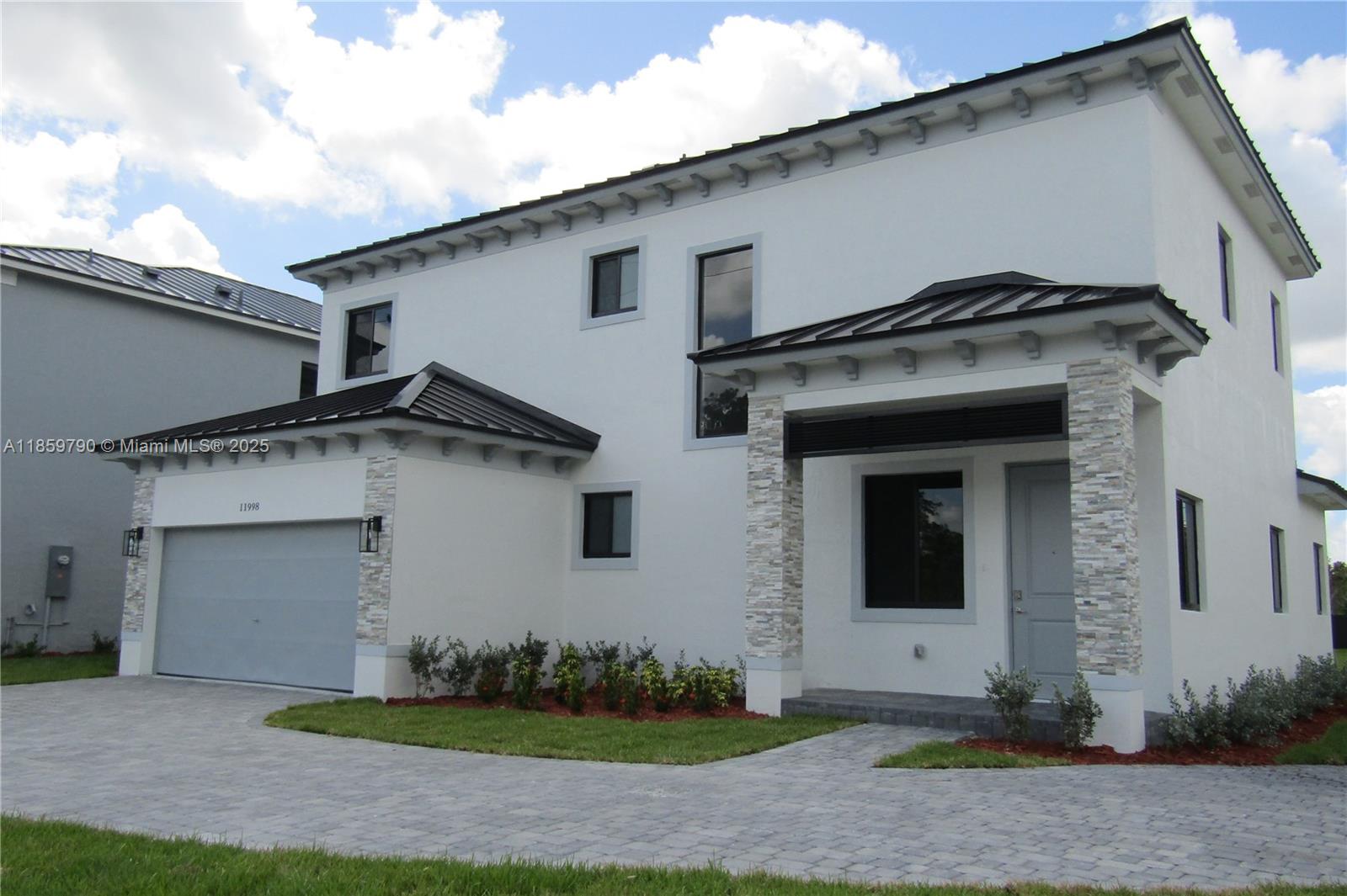 11998 Southwest 232nd Street Homestead, FL 33170 - Photo 23 of 30 a view of a white house with a yard and garage