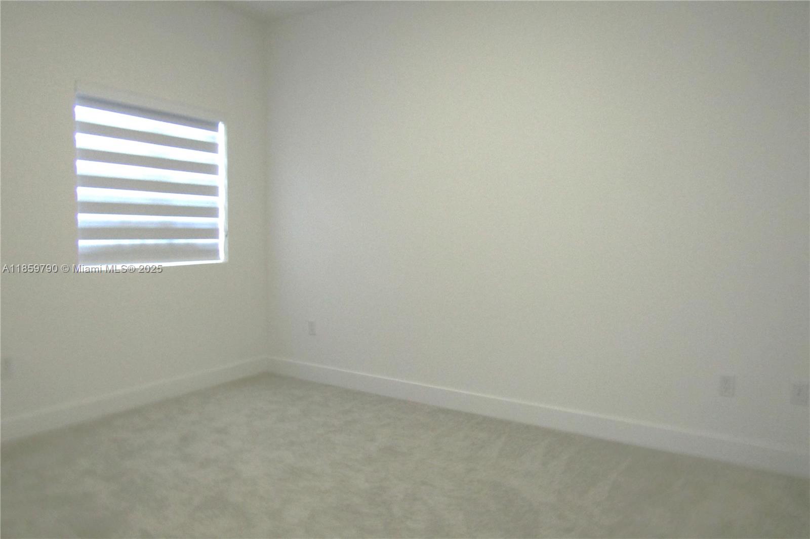 11998 Southwest 232nd Street Homestead, FL 33170 - Photo 9 of 30 a view of an empty room with a window