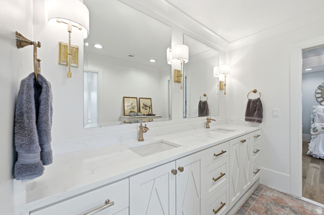 71 Farm Road Midway, UT 84049 - Photo 55 of 92 Dual vanity with white cabinetry and integrated sinks, complemented by polished hardware and wall-mounted sconces