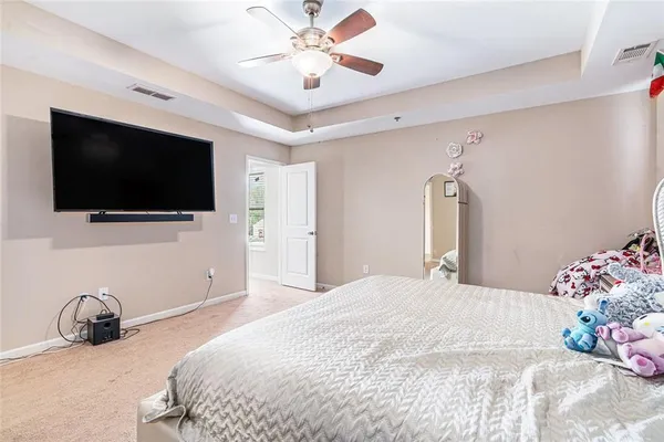 a bedroom with a bed and a flat screen tv