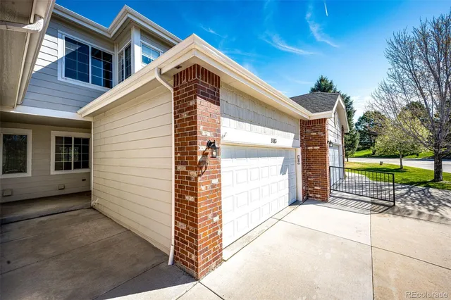 a kitchen with stainless steel appliances kitchen island granite countertop a refrigerator a stove a sink dishwasher and white cabinets with wooden floor