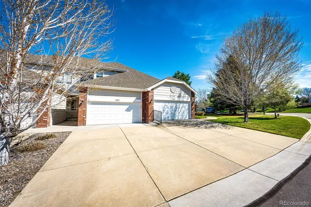 a kitchen with granite countertop a refrigerator and a stove top oven
