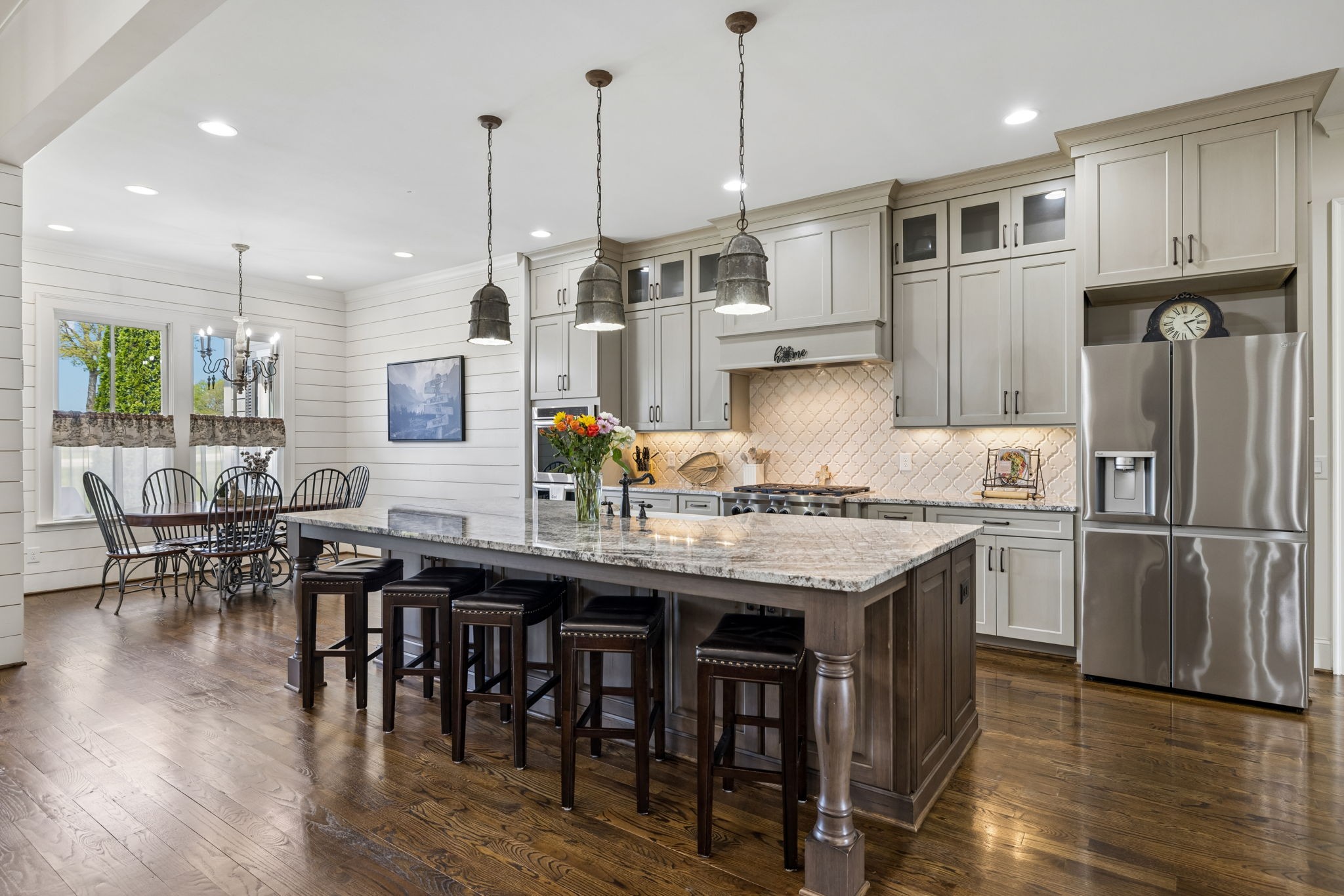 6033 Native Pony Trail College Grove, TN 37046 - Photo 25 of 87 a kitchen with granite countertop a table chairs stainless steel appliances and wooden floor