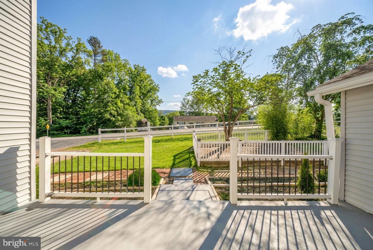 671 Pine Ridge Drive Front Royal, VA 22630 - Photo 16 of 108 Sunny porch view with lush greenery.