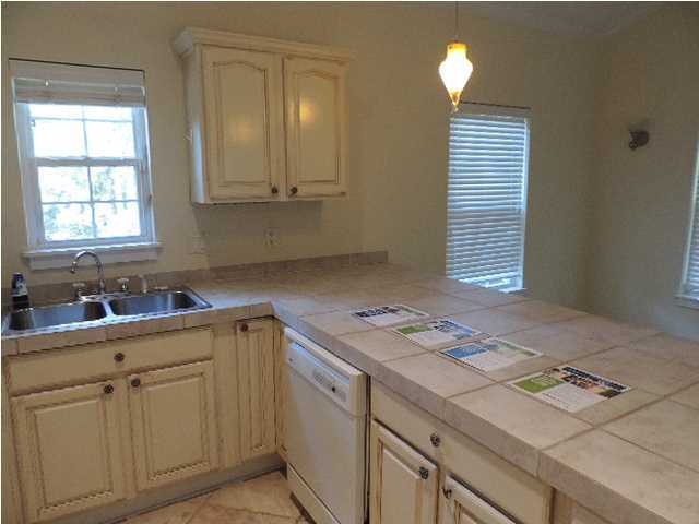 1102 East Nursery Road Santa Rosa Beach, FL 32459 - Photo 11 of 11 a kitchen with a sink cabinets and window