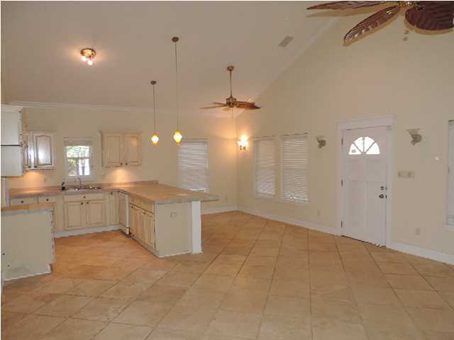 1102 East Nursery Road Santa Rosa Beach, FL 32459 - Photo 3 of 11 a large kitchen with lot of counter top and white cabinets