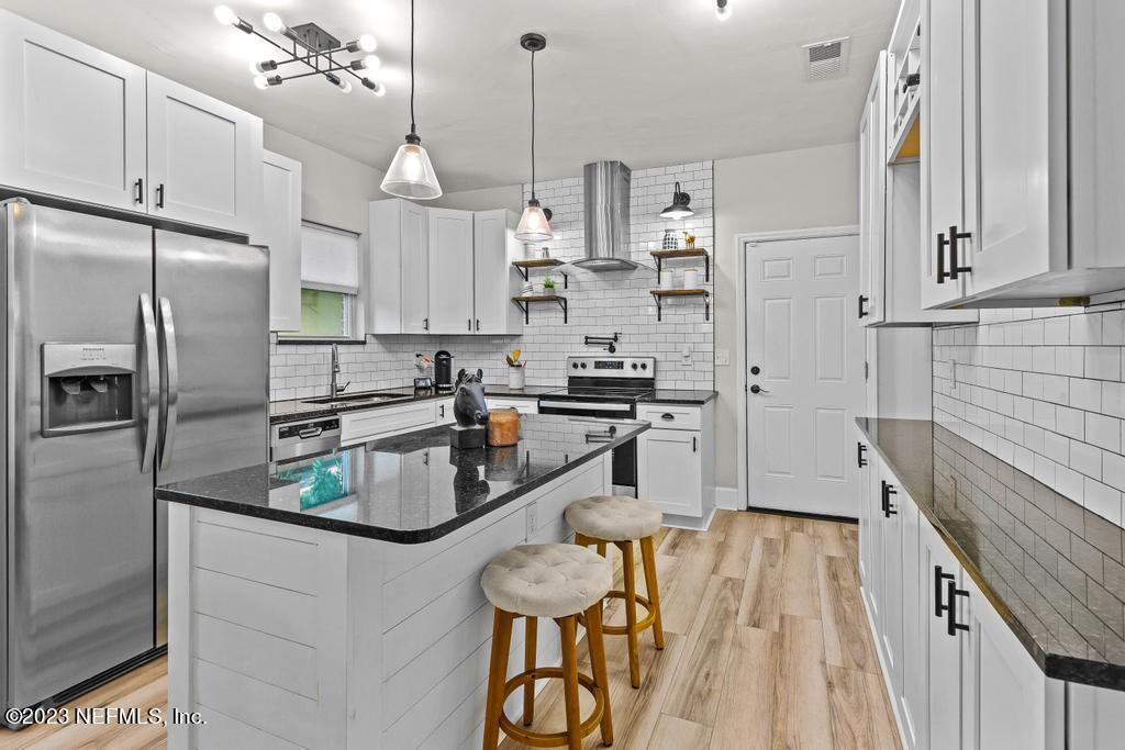 4635 Attleboro Street Jacksonville, FL 32205 - Photo 13 of 27 a kitchen with refrigerator and countertop