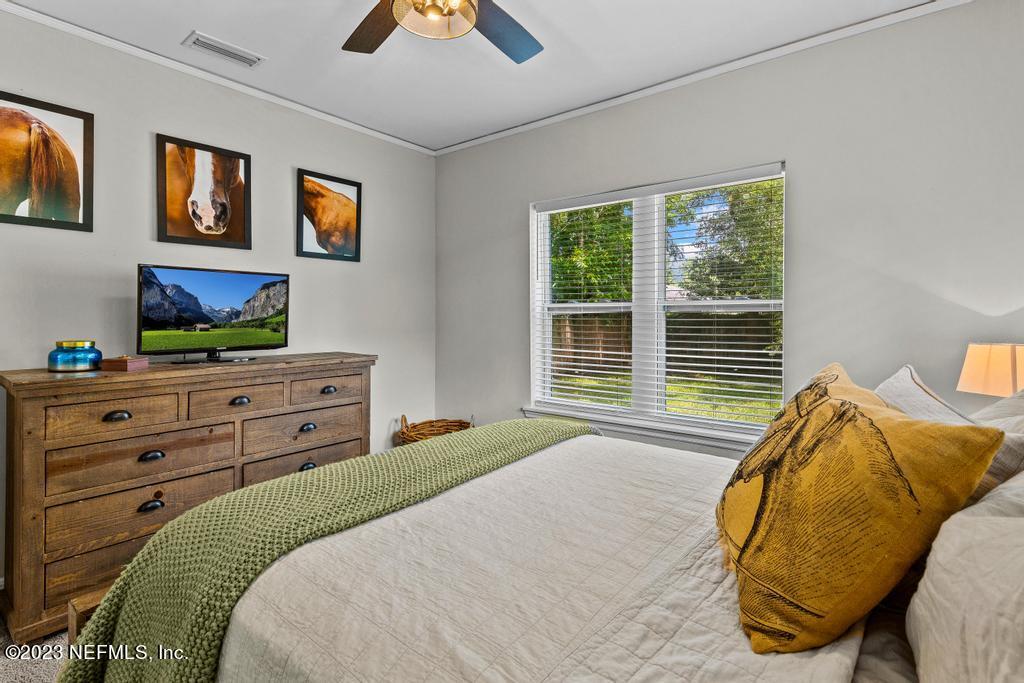 4635 Attleboro Street Jacksonville, FL 32205 - Photo 17 of 27 a bedroom with a bed and a flat tv screen on dresser