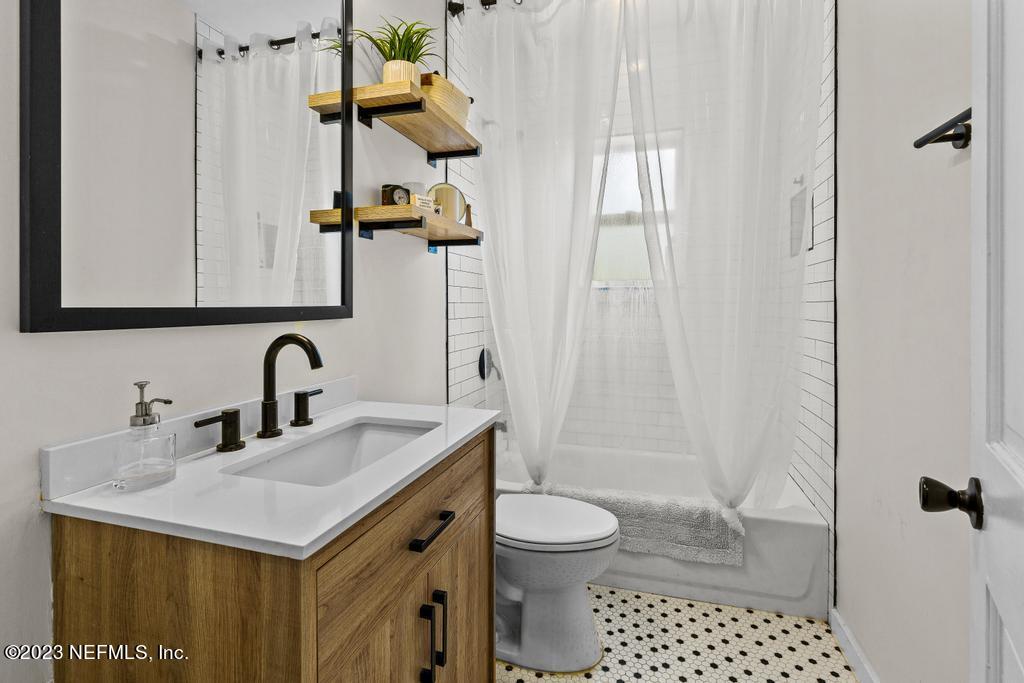4635 Attleboro Street Jacksonville, FL 32205 - Photo 18 of 27 a bathroom with a sink a toilet and shower