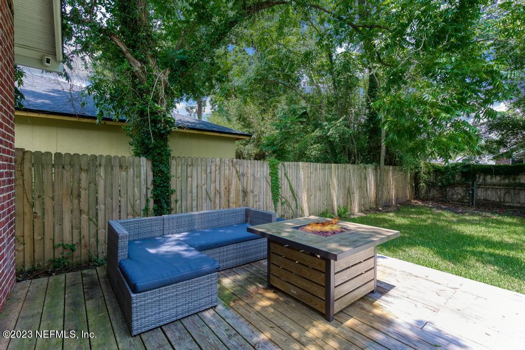 4635 Attleboro Street Jacksonville, FL 32205 - Photo 23 of 27 a backyard of a house with fountain table and chairs