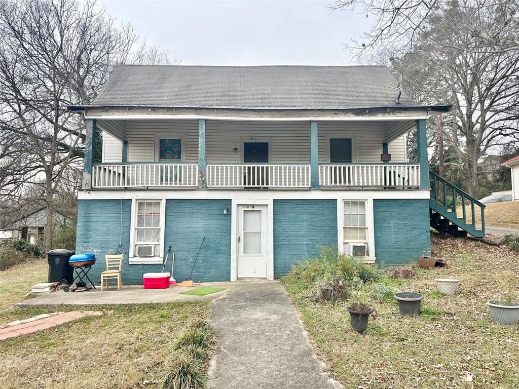 1307 Ave B Rome, GA 30165 - Photo 1 of 1 a view of a white house with large windows and a yard