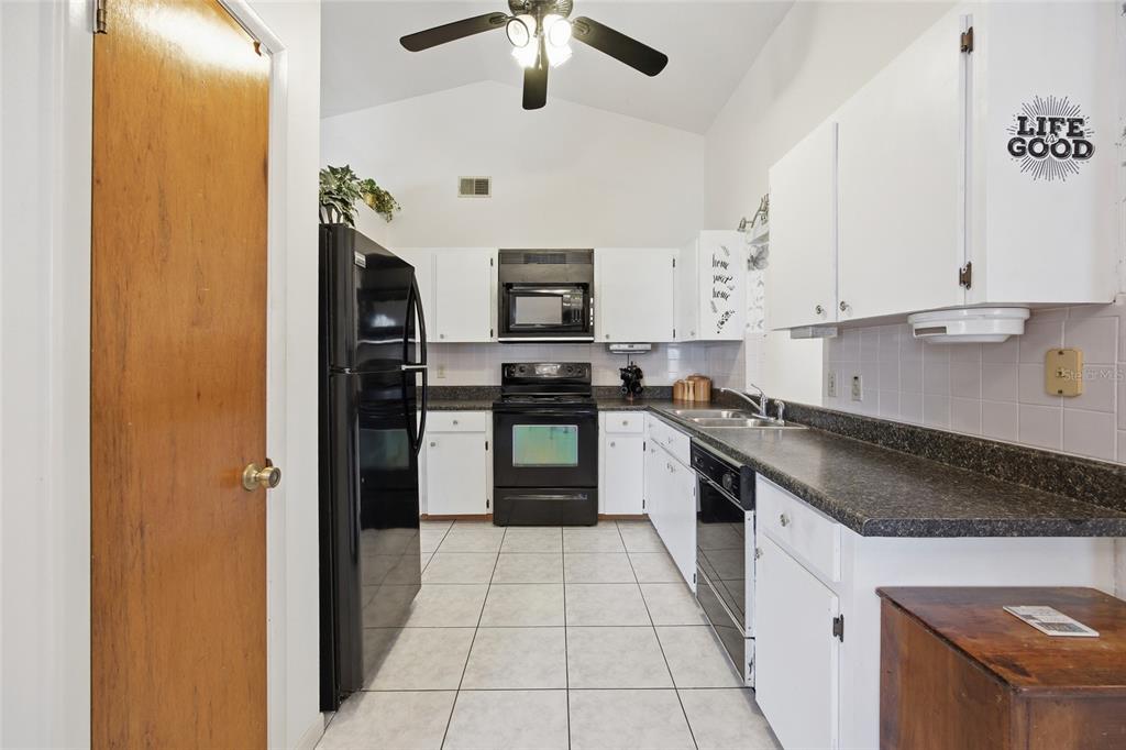 549 Silver Course Run Ocala, FL 34472 - Photo 12 of 48 a kitchen with stainless steel appliances granite countertop a sink and a stove