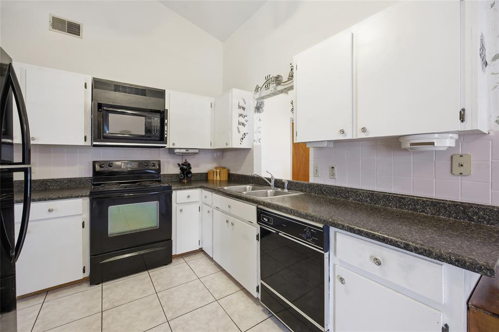 549 Silver Course Run Ocala, FL 34472 - Photo 13 of 48 a kitchen with granite countertop cabinets and stainless steel appliances