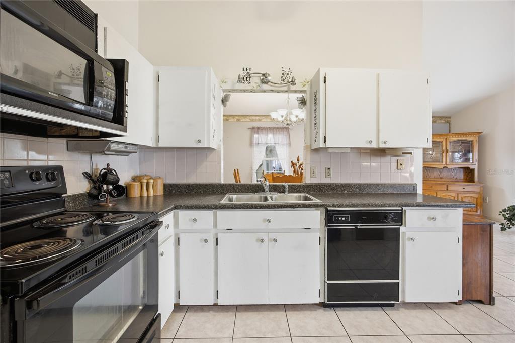 549 Silver Course Run Ocala, FL 34472 - Photo 14 of 48 a kitchen with white cabinets and appliances