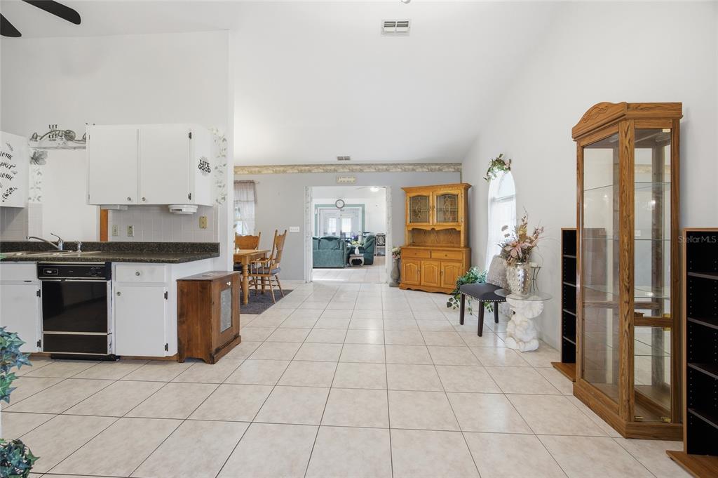 549 Silver Course Run Ocala, FL 34472 - Photo 15 of 48 a kitchen with stainless steel appliances kitchen island granite countertop a stove a sink and a refrigerator