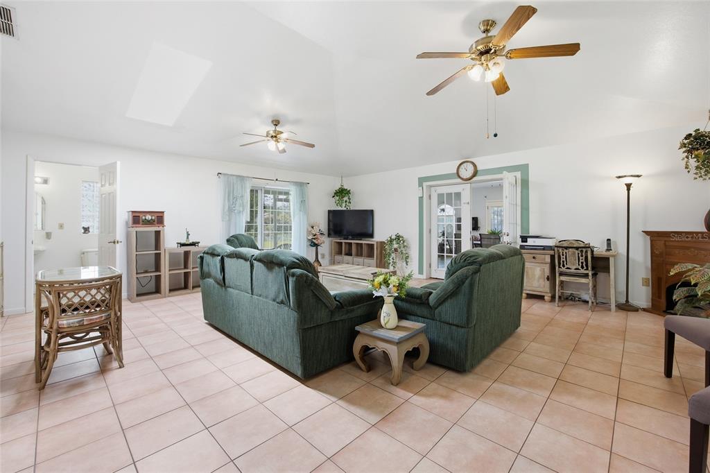 549 Silver Course Run Ocala, FL 34472 - Photo 17 of 48 a living room with furniture and a flat screen tv