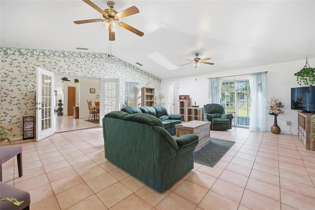 549 Silver Course Run Ocala, FL 34472 - Photo 18 of 48 a living room with furniture and a chandelier