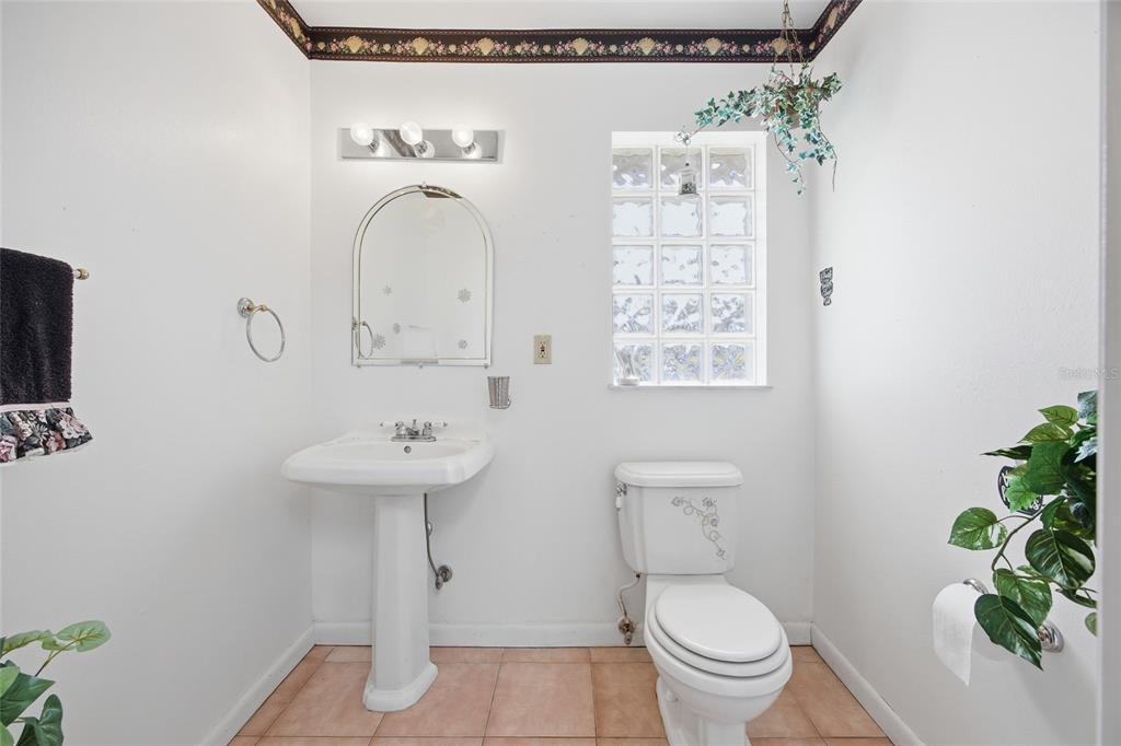 549 Silver Course Run Ocala, FL 34472 - Photo 19 of 48 a bathroom with a toilet a sink and a mirror