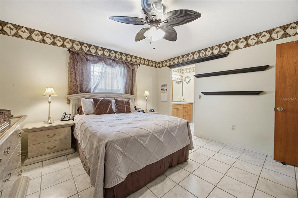 549 Silver Course Run Ocala, FL 34472 - Photo 20 of 48 a bedroom with a bed and a ceiling fan