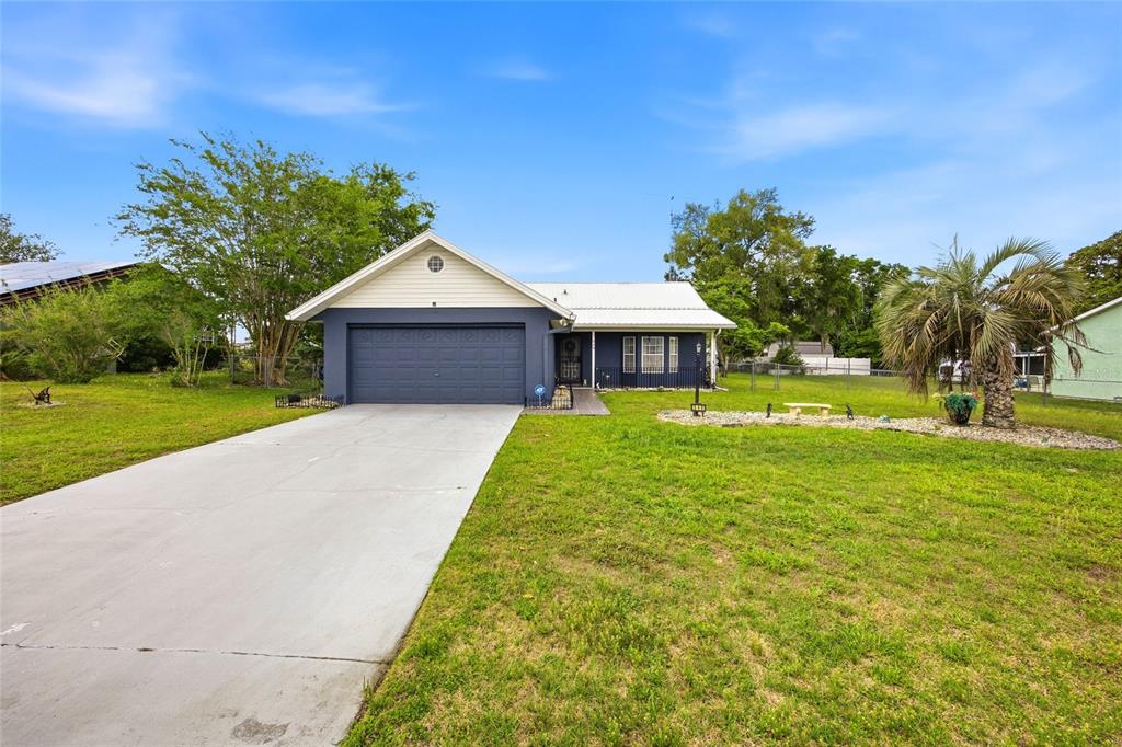 549 Silver Course Run Ocala, FL 34472 - Photo 2 of 48 a front view of a house with a yard