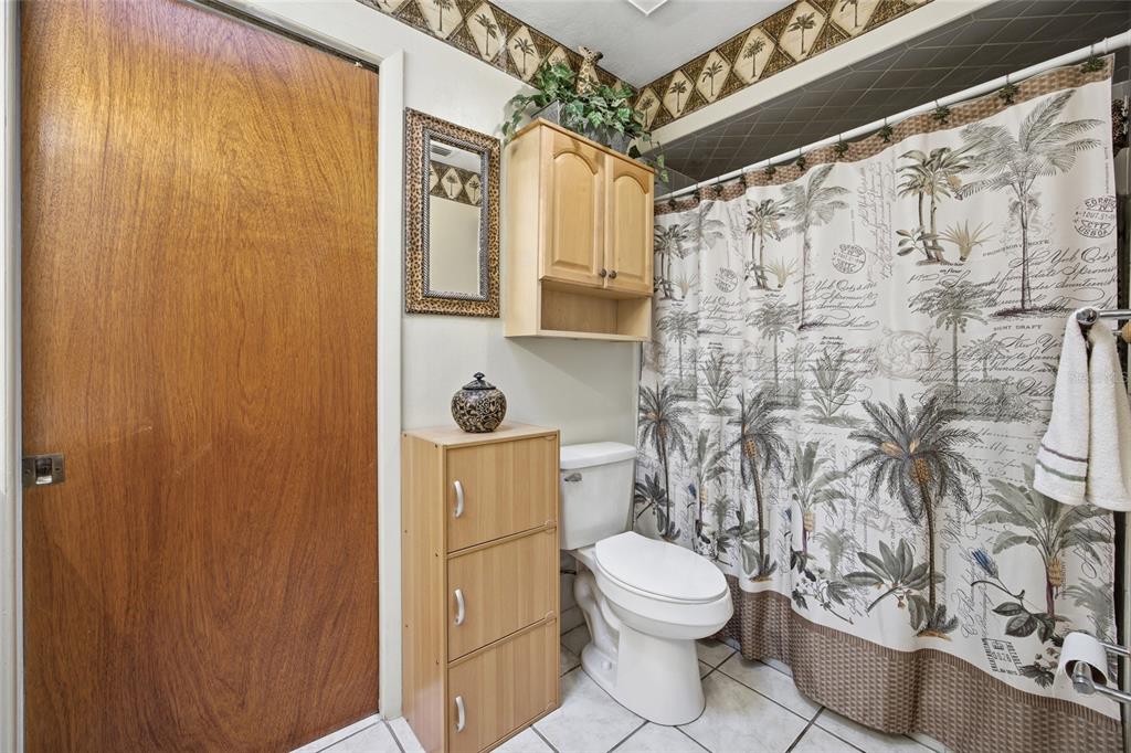 549 Silver Course Run Ocala, FL 34472 - Photo 23 of 48 a bathroom with a toilet and shower curtain