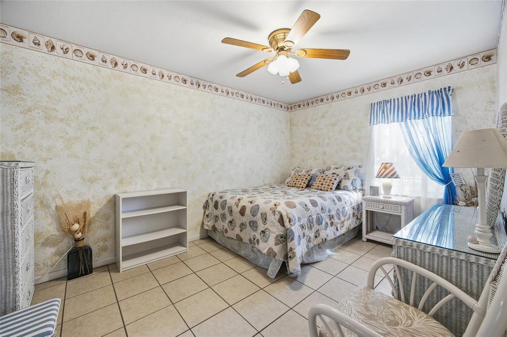 549 Silver Course Run Ocala, FL 34472 - Photo 25 of 48 a bedroom with a bed and a chandelier