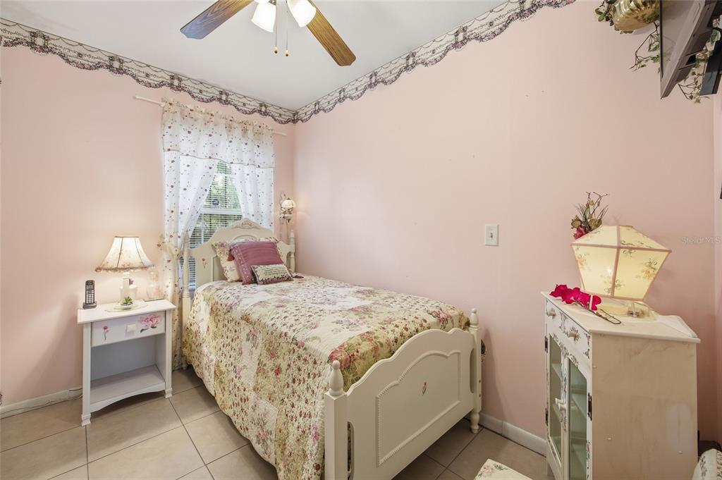 549 Silver Course Run Ocala, FL 34472 - Photo 28 of 48 a bedroom with a bed and a chandelier