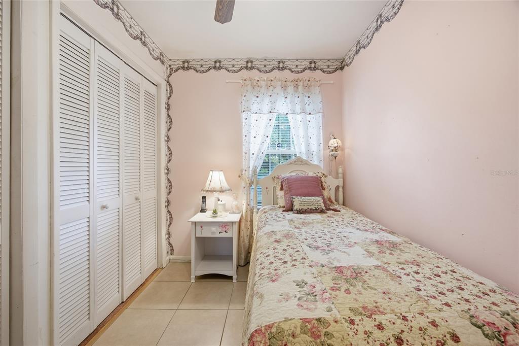 549 Silver Course Run Ocala, FL 34472 - Photo 29 of 48 a bedroom with a bed and a chandelier